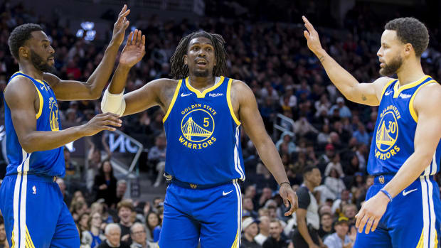 Warriors forward Andrew Wiggins celebrates with teammates after a play.